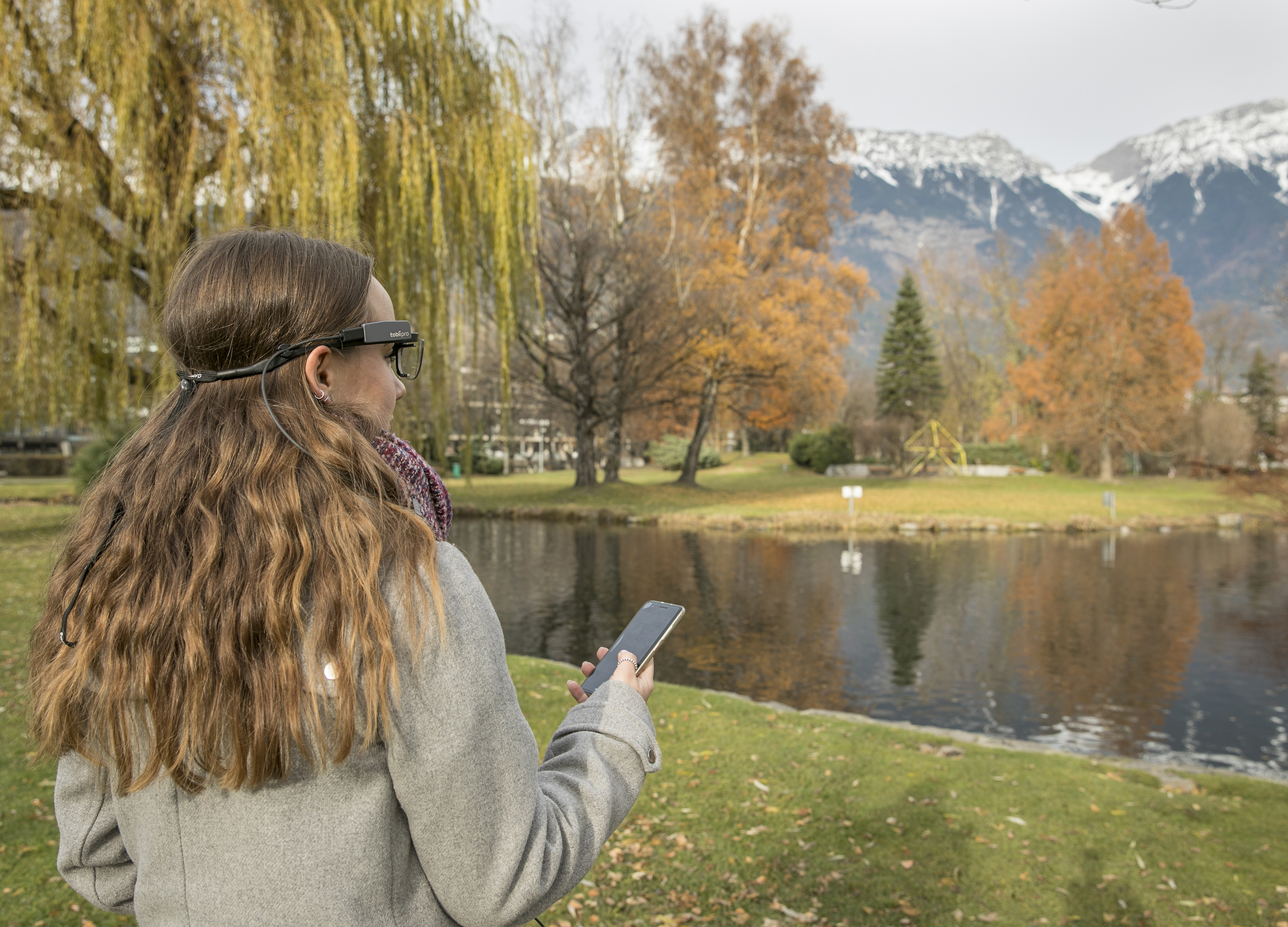 An image of a scientist at a mountain lake